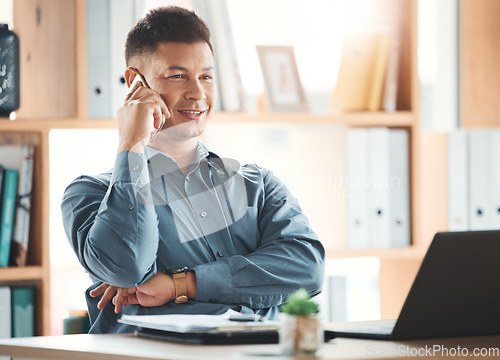 Image of Office, laptop and man on phone call at desk with smile, crm and b2b communication at advisory startup. Business manager, conversation and networking, happy businessman speaking on smartphone at work