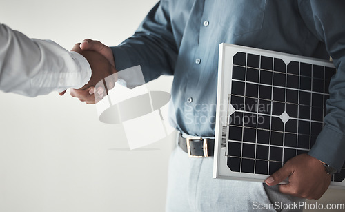 Image of Closeup, handshake and business with solar panels, mockup and partnership for sustainability. Zoom, men and employees with gesture for collaboration, eco friendly or energy for electricity or meeting