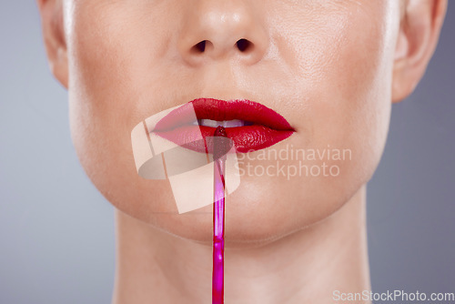 Image of Red lipstick, lips and woman isolated on a studio background for makeup or product promotion. Model face with mouth closeup for cosmetics gloss, shine or color makeup stick with skincare and beauty