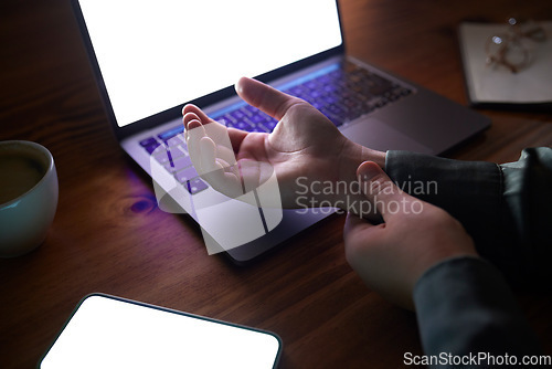 Image of Office, night and woman with wrist pain, injury or accident while working on a project with a laptop. Medical emergency, professional and female employee with a muscle sprain in her hand in workplace