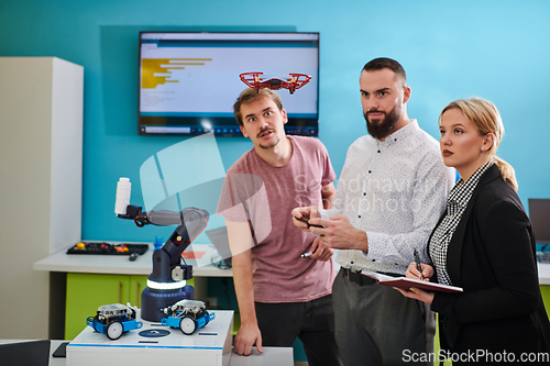 Image of A group of students working together in a laboratory, dedicated to exploring the aerodynamic capabilities of a drone