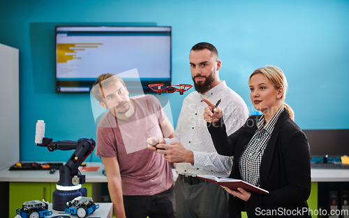 Image of A group of students working together in a laboratory, dedicated to exploring the aerodynamic capabilities of a drone