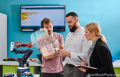 Image of A group of students working together in a laboratory, dedicated to exploring the aerodynamic capabilities of a drone