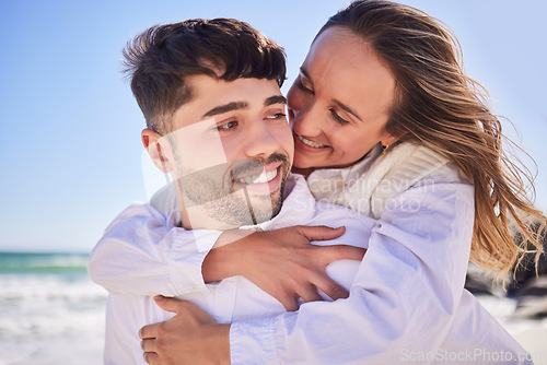 Image of Love, piggyback and happy couple at the beach on date for romance, valentines day or anniversary. Romantic, happiness and young man and woman having fun together by the ocean on holiday in Australia.