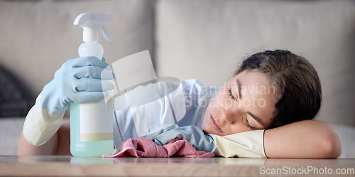 Image of Tired woman, housekeeping and sleeping on table with detergent bottle by the living room sofa at home. Female exhausted from spring cleaning, burnout or nap after disinfection with sanitizer bottle