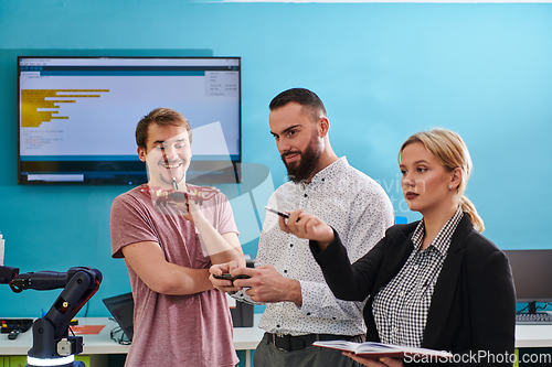 Image of A group of students working together in a laboratory, dedicated to exploring the aerodynamic capabilities of a drone