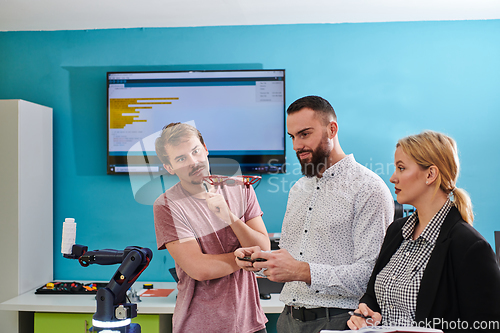 Image of A group of students working together in a laboratory, dedicated to exploring the aerodynamic capabilities of a drone