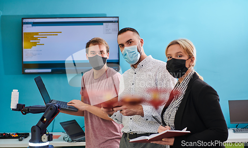 Image of A group of students working together in a laboratory, dedicated to exploring the aerodynamic capabilities of a drone