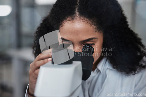 Image of Science, microscope and research with a doctor black woman at work in a lab for innovation or development. Medical, analysis and sample with a female scientist working in a laboratory on breakthrough