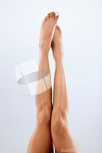 Image of Legs, feet and skin with woman and beauty, epilation with laser hair removal, waxing and pedicure on studio background. Skincare, dermatology and spa treatment with cosmetics, glow and mockup space