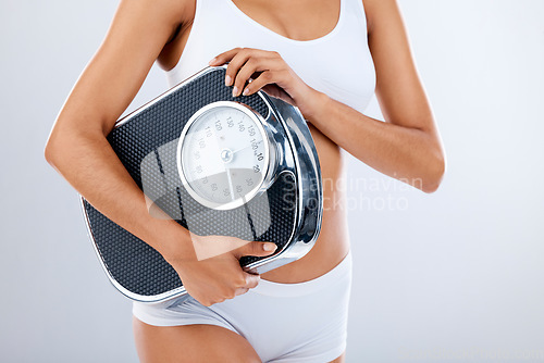 Image of Woman, body and scale with fitness and health, diet or detox to lose weight with exercise, healthy lifestyle and wellness. Nutrition, workout and weightloss, healthcare isolated on studio background