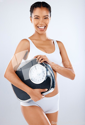 Image of Black woman, body and scale with fitness and health, diet or detox to lose weight with exercise, healthy lifestyle and wellness. Nutrition, workout and weightloss portrait on studio background