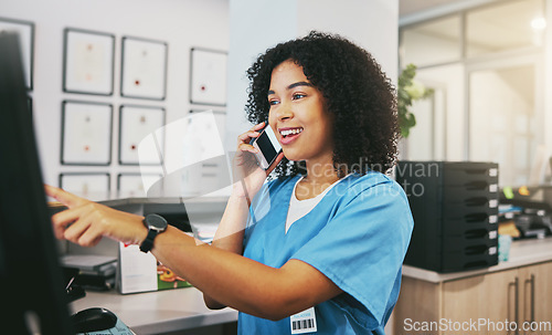 Image of Phone call, nurse and black woman with computer in hospital for healthcare or telehealth. Medical, question and happy female doctor pointing at desktop while talking or chatting on mobile smartphone.