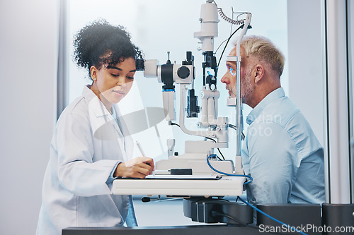 Image of Vision, eye exam and writing with a doctor woman or optometrist testing the eyes of a man patient in a clinic. Hospital, medical or consulting with a female eyesight specialist and senior male