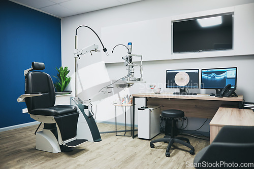 Image of Optometry, empty room and equipment for vision test for eye care in a optical clinic or store. Optic healthcare, ophthalmology and computers, technology or machines in optometrist consultation office