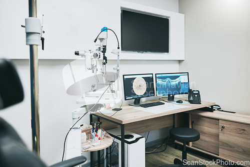 Image of Ophthalmology, computer and empty room with equipment for vision, healthcare and consultation. Technology, professional and consulting office with a chair for care of eyes and a monitor for results