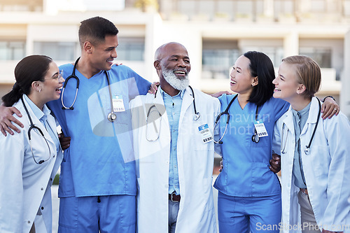 Image of Doctor, hug and smile for healthcare collaboration, partnership, unity or trust in the city. Happy group of medical team smiling and hugging in teamwork support, nursing or medicine in solidarity