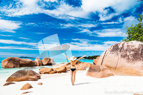Image of Happy woman rising hands to the sky on summer vacations on Seychelles