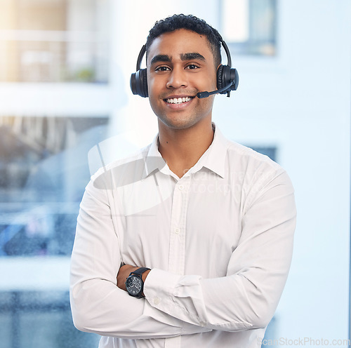 Image of Call center, smile with portrait of man in office for customer support, telemarketing and communications. Consulting, happy and sales with employee and arms crossed for help desk, advisory and crm