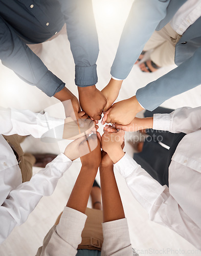 Image of Teamwork, diversity and group holding hands in circle for support, trust and team building together. Business people in huddle standing in solidarity at office workshop and commitment goal from above