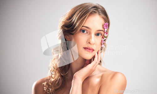 Image of Beauty flowers, face portrait or woman with floral product, sustainable agriculture and relax natural skincare. Facial makeup, nature plant cosmetic or eco friendly girl isolated on studio background