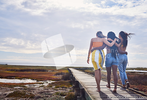 Image of Relax, group and boardwalk with friends at beach for travel vacation, support or summer break with blue sky mockup. Diversity, holiday and nature with women walking together for bonding, hug or peace