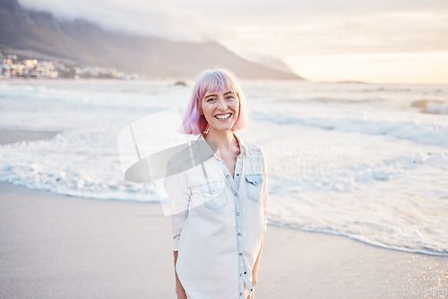 Image of Sunset, beach and portrait of woman with smile on face, having fun in waves while on holiday in Indonesia. Sea, freedom and travel, happy gen z girl playful on summer ocean vacation on evening walk.