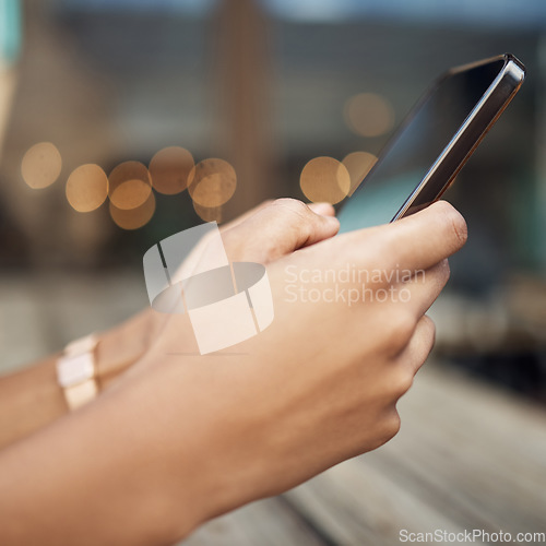 Image of Hands, phone and communication chatting in the city for social media or texting on table. Hand of person on mobile smartphone talking or online browsing, internet with 5G connection in town on mockup