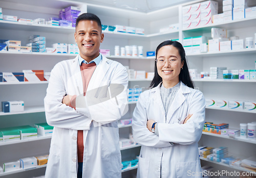 Image of Portrait, teamwork and pharmacists with arms crossed in pharmacy, drugstore and medicine shop. Healthcare, pharma wellness and happy, proud and confident smile of medical doctors, man and Asian woman