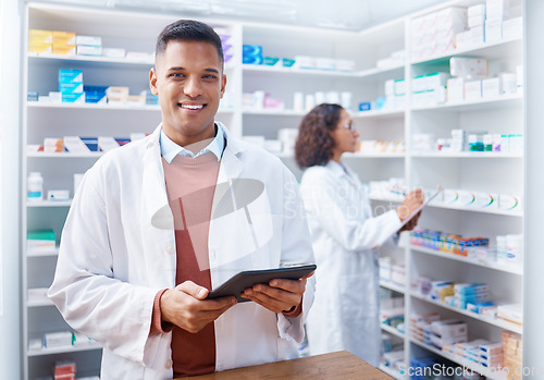 Image of Tablet, man and portrait of pharmacist in pharmacy for healthcare stock or online consultation. Medication research, telehealth technology and happy male medical doctor with touchscreen in drugstore.