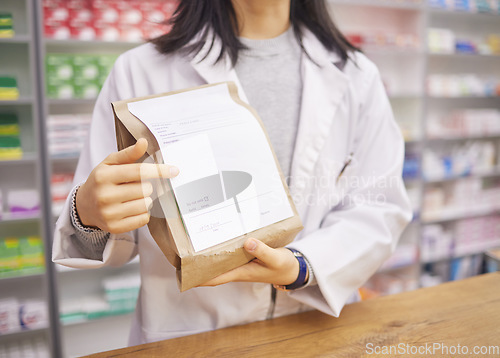 Image of Prescription, medicine and hands of a pharmacist with a bag for health, medical pills and drugs. Retail, wellness and woman at a pharmacy for service, healthcare advice and showing information