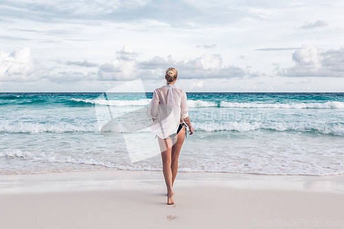 Image of Woman on summer vacations at tropical beach of Mahe Island, Seychelles.