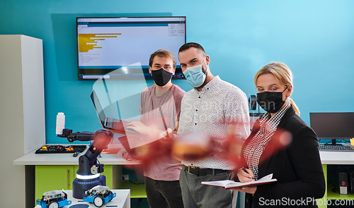 Image of A group of students working together in a laboratory, dedicated to exploring the aerodynamic capabilities of a drone