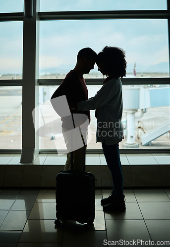 Image of Silhouette, travel and love with couple in airport and hug for departure, flight and say goodbye. Shadow, holiday and sad man and woman leave in embrace by window for journey, international