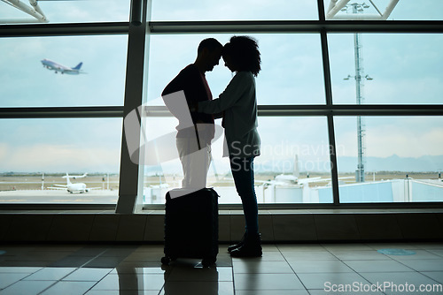 Image of Airport, couple and silhouette of love, hug and leaving on vacation on a airplane flight. Plane departure, holiday and young people shadow by a window for journey, vacation break or immigration