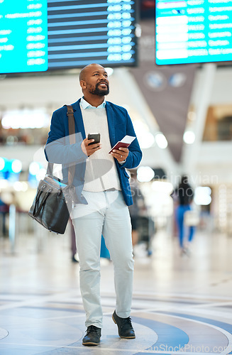 Image of Black man checking flight schedule with phone and ticket walking in airport terminal, holding passport for business trip. Smile, travel app and happy businessman boarding international destination.