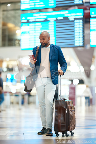 Image of Black man with phone, luggage and checking flight schedule online, waiting in terminal for international business trip. Internet, travel app and businessman at airport for international destination.