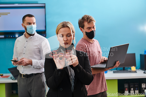 Image of A group of students working together in a laboratory, dedicated to exploring the aerodynamic capabilities of a drone