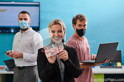 Image of A group of students working together in a laboratory, dedicated to exploring the aerodynamic capabilities of a drone