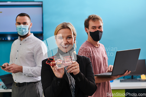 Image of A group of students working together in a laboratory, dedicated to exploring the aerodynamic capabilities of a drone