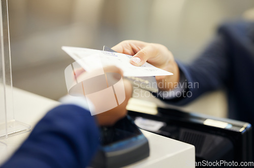 Image of Hands, airport and service agent with ticket, passport or documents to board plane at terminal counter. Hand of female passenger assistant giving access for travel, security or immigration papers