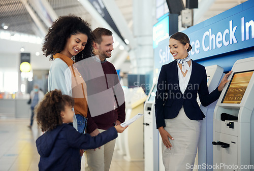 Image of Woman, services agent and family at airport by self service check in station for information, help or FAQ. Happy female passenger assistant helping travelers register or book airline flight ticket