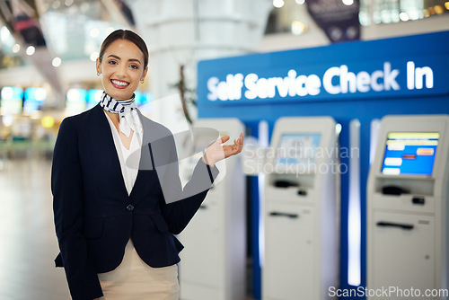 Image of Woman, passenger assistant and airport for check in by self service station or machine for information, help or FAQ. Portrait of happy female services agent standing ready to assist people in travel