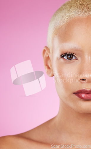 Image of Beauty, half face and woman in portrait with makeup, skincare glow, eye and healthy skin on pink background. Natural cosmetics, lashes and mockup space, dermatology and cosmetic shine with wellness