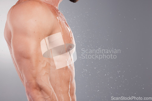 Image of Body, closeup and man with water, muscular and hygiene for wellness, cleaning and guy on grey studio background. Zoom, male bodybuilder or gentleman wet, bare and cosmetics for smooth or healthy skin