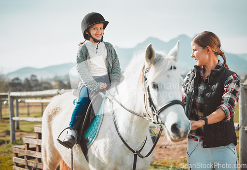 Image of .Happy child on horse, woman with harness on ranch and mountain in background lady and animal walking on field. Countryside lifestyle, rural nature and farm animals, mom girl kid to ride pony in USA.