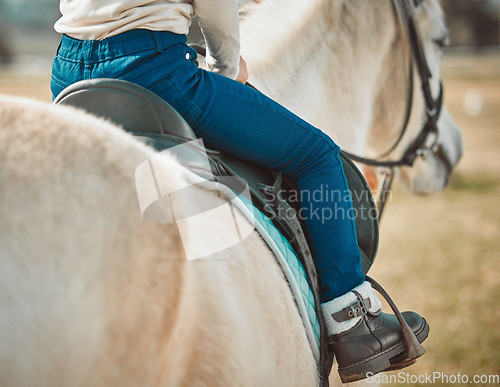 Image of .Sports, riding and shoes of girl on horse in countryside for hobby, equestrian and learning. Cowgirl, summer and pasture with child jockey and pet on animal ranch for summer, vacation and adventure.