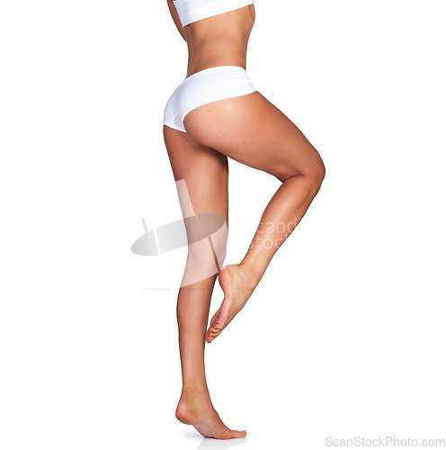Image of Skincare, legs and woman on mockup in studio for grooming, smooth and soft against a white background. Body care, leg and girl model relax in underwear for skin, glow or luxury beauty while isolated