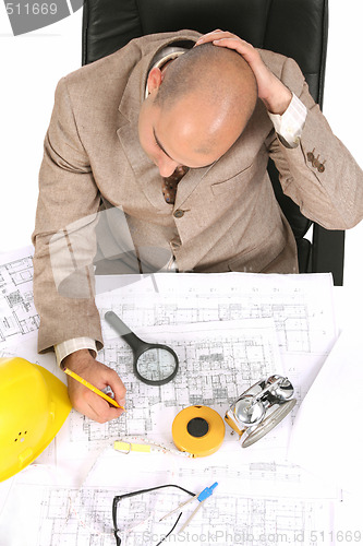 Image of Businessman thinking with architectural plans