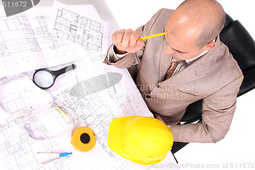 Image of Businessman thinking with architectural plans